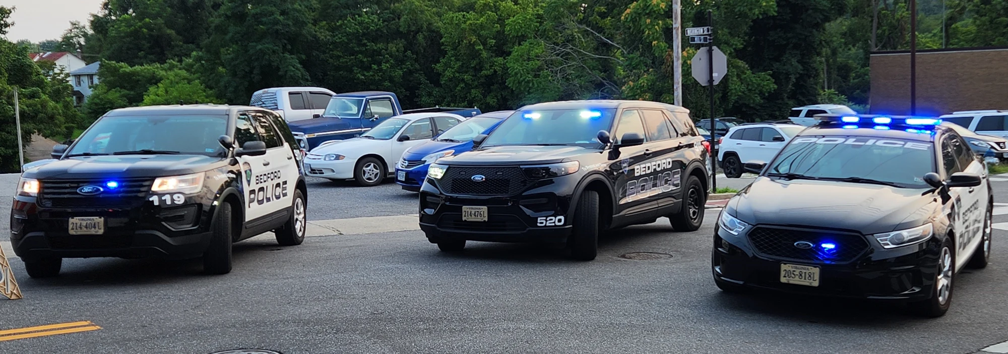 Three Bedford police vehicles with their blue lights on