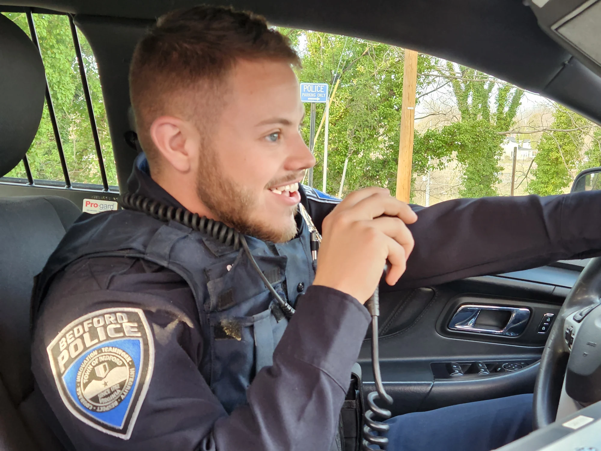 Bedford police officer in a patrol vehicle